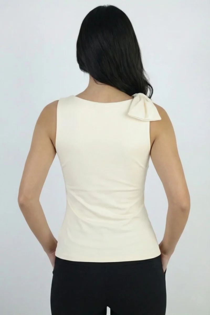 Bluzka damska ecru widok z tyłu, elegancki fason bez rękawów z ozdobną kokardą na ramieniu.